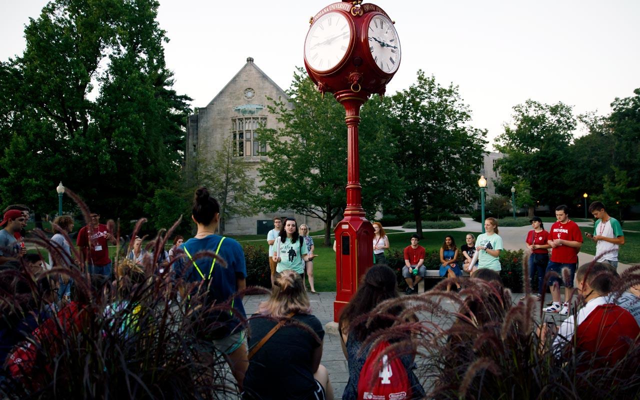 IU Bloomington students at orientation standing by a clock tower.