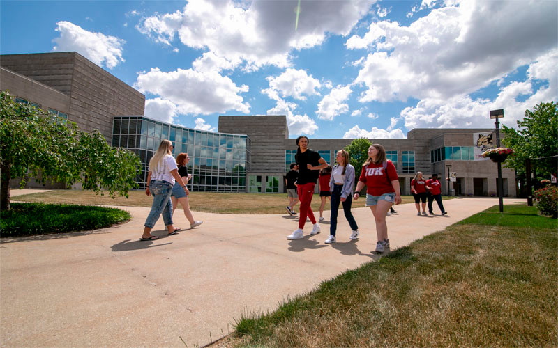 Students walk in front of a building on IU Kokomo’s campus.
