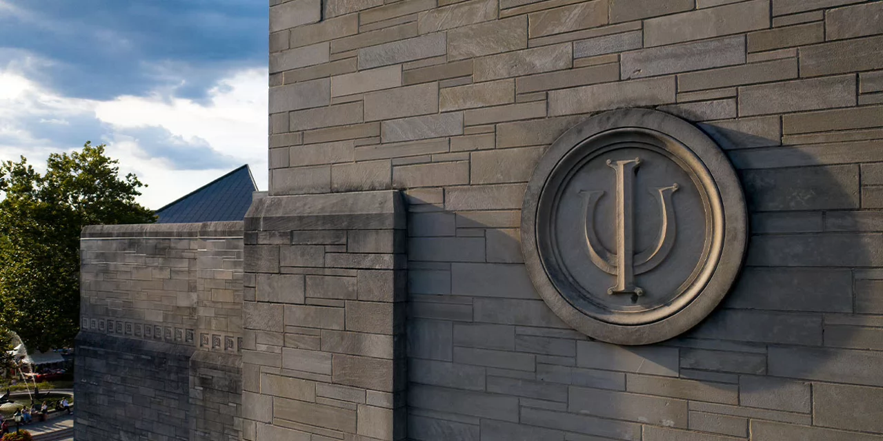 Trident on side of limestone building