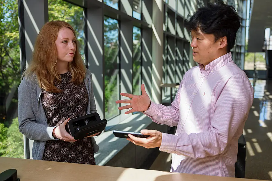 Assistant professor of health informatics Hee-Tae Jung, right, and IU Ph.D. student Erica Babb of the IU Luddy School of Informatics, Computing, and Engineering in Indianapolis with VR technology used to assist individuals with Alzheimer's disease.