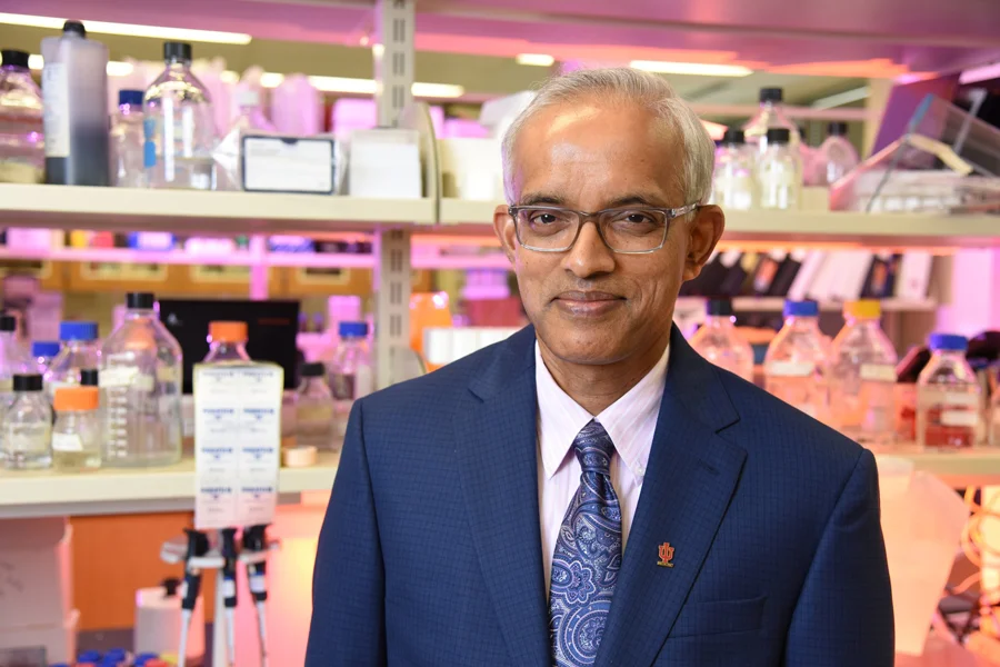 Dr. Harikrishna Nakshatri, PhD smiles and poses in a research laboratory.