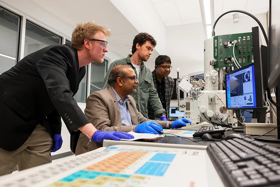 From left, Mark Woollam, a senior research scientist; Mangilal Agarwal, a professor of biomedical engineering and informatics; Eray Schulz, a chemistry graduate student; and Dipak Maity, a research scientist, review test results at IU's Integrated Nanosystems Development Institute look at research data on a computer.