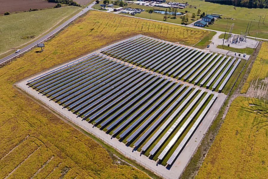 an array of solar panels occupy a farm field in rural Indiana