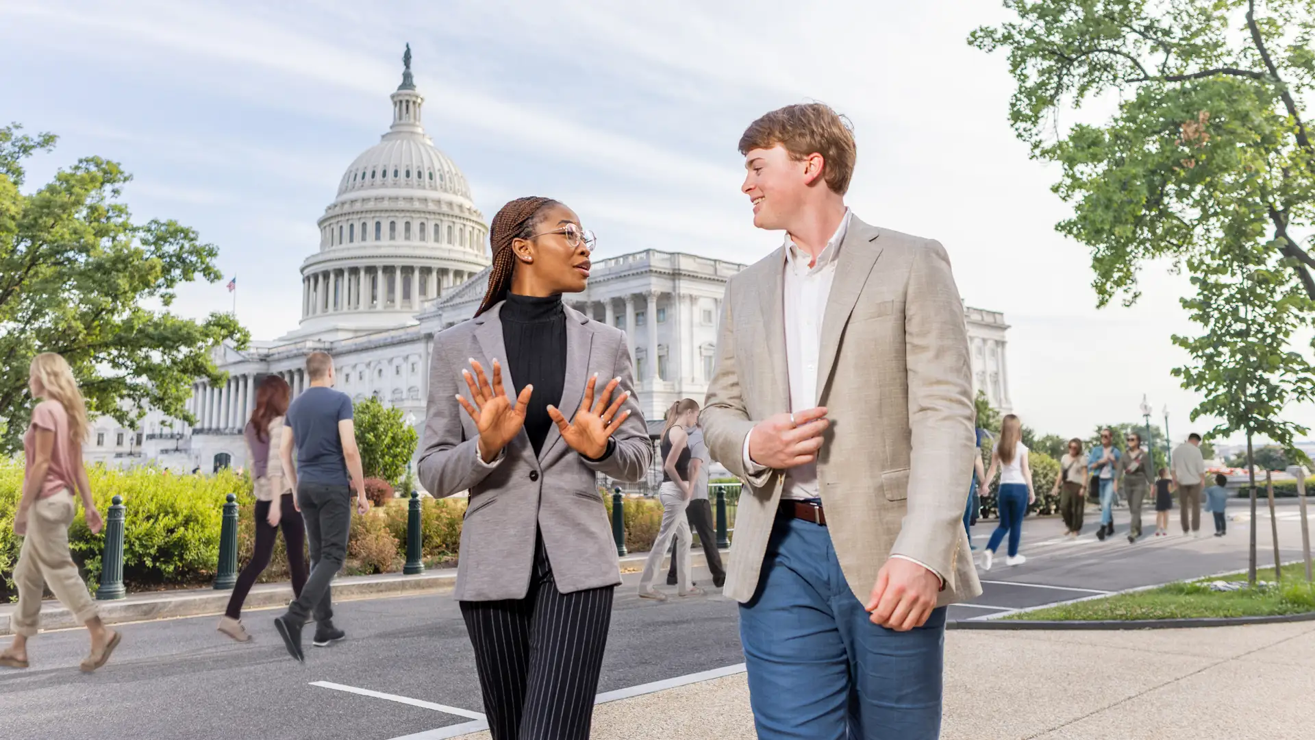 A female and male student talk near the US Capitol building in Washington, DC